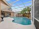 Inviting screened-in pool with well-maintained deck and landscaping provides a backyard oasis at 807 Grovesmere Loop, Ocoee, FL 34761