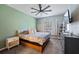 Relaxing bedroom featuring a ceiling fan, natural light, and a comfortable bed setup at 12079 Alder Branch Loop, Orlando, FL 32824