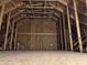 Interior view of attic space with exposed wooden beams and plywood walls, offering potential for future expansion at 347 Mission Rd, Oviedo, FL 32765