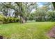 Beautiful backyard featuring lush lawn and mature trees, offering privacy at 347 Mission Rd, Oviedo, FL 32765