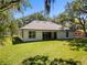 Expansive backyard featuring lush green lawn, modern windows, and inviting sliding glass doors for seamless indoor/outdoor living at 347 Mission Rd, Oviedo, FL 32765