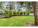 Landscaped backyard with privacy fence and well-manicured lawn at 347 Mission Rd, Oviedo, FL 32765