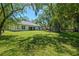 Exterior shot of home with large backyard and mature shade trees surrounding property at 347 Mission Rd, Oviedo, FL 32765