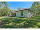 Exterior view of the home showcasing a manicured lawn and fresh paint at 347 Mission Rd, Oviedo, FL 32765