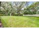 Expansive backyard featuring lush green grass and mature trees at 347 Mission Rd, Oviedo, FL 32765
