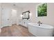 Bathroom with double sink vanity and modern soaking tub at 347 Mission Rd, Oviedo, FL 32765