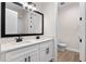 Bathroom features a dual sink vanity with modern fixtures and a toilet in an adjacent room at 347 Mission Rd, Oviedo, FL 32765