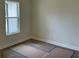 Bedroom with wood floors and large window with natural lighting at 347 Mission Rd, Oviedo, FL 32765