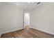 Bright bedroom featuring hardwood floors, neutral paint, and an open doorway at 347 Mission Rd, Oviedo, FL 32765