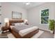 Cozy bedroom with hardwood floors, a decorative rug, and a view of the lush green outdoor space at 347 Mission Rd, Oviedo, FL 32765