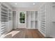 Walk-in closet with custom shelving and drawers at 347 Mission Rd, Oviedo, FL 32765