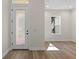 Bright entryway with wood flooring, frosted glass door, and natural light from side window at 347 Mission Rd, Oviedo, FL 32765