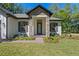 Inviting home entrance featuring stone accents, manicured landscaping, and a brick pathway at 347 Mission Rd, Oviedo, FL 32765