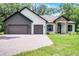 Charming single-story home with brick driveway, three-car garage, stone accents, and manicured lawn at 347 Mission Rd, Oviedo, FL 32765