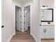 Hallway with access to bedrooms and a bathroom featuring modern fixtures at 347 Mission Rd, Oviedo, FL 32765