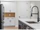 Stainless steel refrigerator and black faucet on kitchen island at 347 Mission Rd, Oviedo, FL 32765
