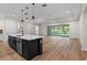 Spacious kitchen features an island with a sink and pendant lighting, and an open layout at 347 Mission Rd, Oviedo, FL 32765