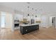 Modern kitchen featuring a large island, stainless steel appliances, and white cabinetry at 347 Mission Rd, Oviedo, FL 32765