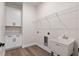 Laundry room showcasing a utility sink, wire rack shelving, and storage cabinets at 347 Mission Rd, Oviedo, FL 32765