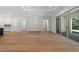 Open-concept living space featuring wood floors, sliding doors to patio, and white trim at 347 Mission Rd, Oviedo, FL 32765
