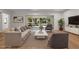 Bright living room with hardwood floors, recessed lighting, and large sliding glass doors to the outdoor space at 347 Mission Rd, Oviedo, FL 32765