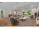 Bright living room with hardwood floors, recessed lighting, and large sliding glass doors to the outdoor space at 347 Mission Rd, Oviedo, FL 32765