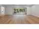 Spacious living room featuring wood floors and sliding glass doors to the backyard at 347 Mission Rd, Oviedo, FL 32765