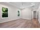 Spacious bedroom featuring tray ceiling, recessed lights, multiple windows, and wood-look flooring at 347 Mission Rd, Oviedo, FL 32765