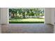 Covered brick patio overlooking a spacious, well-maintained backyard with mature trees at 347 Mission Rd, Oviedo, FL 32765