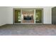 Expansive brick patio with a view into a modern kitchen through large glass doors at 347 Mission Rd, Oviedo, FL 32765