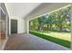 Covered brick patio offers relaxing view of the green backyard with mature trees at 347 Mission Rd, Oviedo, FL 32765