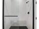 Bathroom showcasing a glass enclosed walk-in shower featuring marble wall tiles and black hardware at 347 Mission Rd, Oviedo, FL 32765
