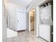 View of entryway with tile flooring, stairs, and washer-dryer stack at 4408 Sun Village Blvd, Kissimmee, FL 34746
