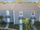 Gray two-story townhouses with dark gray roofs, and covered entrances at 4408 Sun Village Blvd, Kissimmee, FL 34746