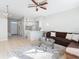 Open concept living room and kitchen with tile floor and ceiling fan at 4408 Sun Village Blvd, Kissimmee, FL 34746