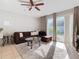 Living room with brown sectional sofa, coffee table, ceiling fan, and sliding glass doors at 4408 Sun Village Blvd, Kissimmee, FL 34746