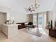 Bright living room includes a brown sectional sofa, coffee table, and access to a patio at 4408 Sun Village Blvd, Kissimmee, FL 34746