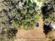 Aerial view of the property showcasing a large yard with mature trees and a trampoline at 849 Orange Oak Dr, Orange City, FL 32763