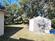 Backyard featuring a shed, surrounded by mature trees and lush greenery at 849 Orange Oak Dr, Orange City, FL 32763