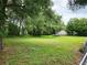 Sprawling backyard with mature trees and a trampoline, creating a private retreat at 849 Orange Oak Dr, Orange City, FL 32763