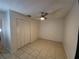 Nice bedroom with ceiling fan, tile flooring, and a closet door at 849 Orange Oak Dr, Orange City, FL 32763