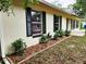 The side of this charming home includes well manicured mulch and plants, as well as dark shutters at 849 Orange Oak Dr, Orange City, FL 32763