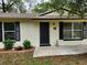 Inviting home entrance, featuring dark-colored shutters and a well-manicured yard at 849 Orange Oak Dr, Orange City, FL 32763