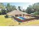 House with a fenced-in pool and patio area; surrounded by lush trees at 8490 Se 110Th Street Rd, Belleview, FL 34420