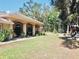 Large backyard with covered patio, playground, and expansive lawn at 8490 Se 110Th Street Rd, Belleview, FL 34420