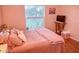 Cozy bedroom with large window and wood flooring at 8490 Se 110Th Street Rd, Belleview, FL 34420