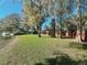 Expansive backyard featuring mature trees and direct access to the tranquil lake at 12139 Palmetto Way, Dunnellon, FL 34432