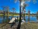 Scenic view of a dock, trees and a lake, creating a tranquil outdoor space to enjoy nature at 12139 Palmetto Way, Dunnellon, FL 34432