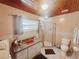 Functional bathroom featuring tiled shower, vanity, and neutral fixtures, providing essential comfort at 12139 Palmetto Way, Dunnellon, FL 34432