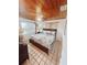 Inviting bedroom with wood ceiling, tile flooring, and a cozy atmosphere, perfect for relaxation at 12139 Palmetto Way, Dunnellon, FL 34432